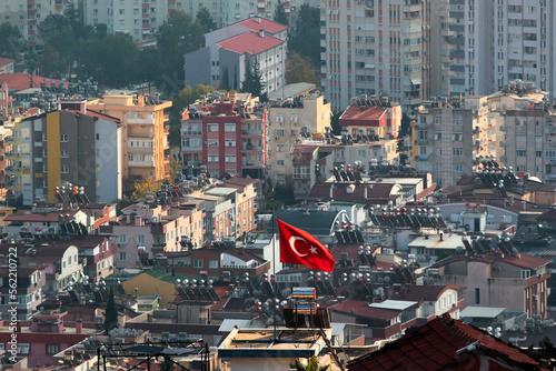 Aerial view of Kepez district in Antalya, Turkey. Turkish flag against residential houses as background. photo