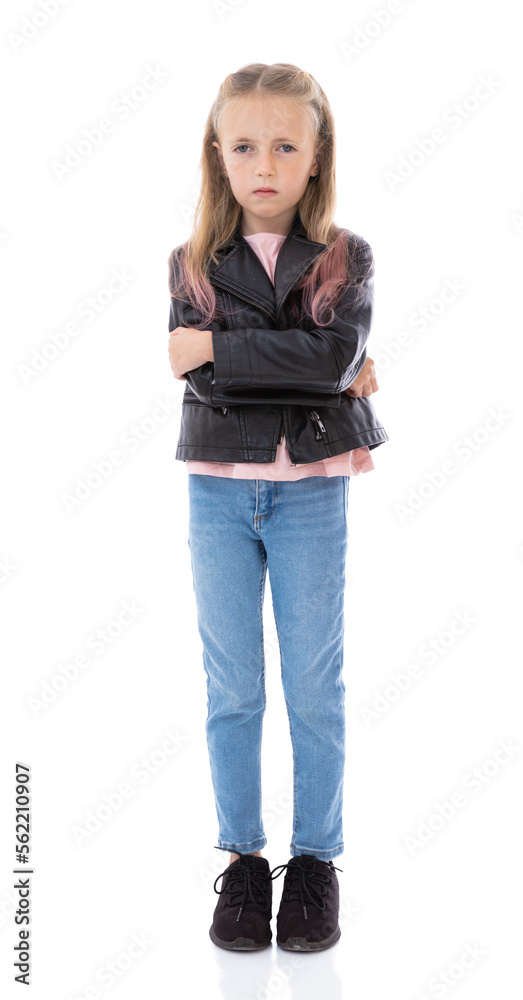 Dissatisfied five year old girl arms crossed over looks at camera posing on white background. Full-length portrait of small child with irritated face. Blonde girl in black leather jacket in studio. Dissatisfied five year old girl arms crossed over looks at camera posing on white background. Full-length portrait of small child with irritated face. Blonde girl in black leather jacket in studio.