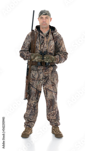 Вuck hunter with a rifle on his shoulder and binoculars. Fifty-year-old man in hunting uniform standing in studio, isolated on white background. Full length portrait of a mature hunter with a shotgun.