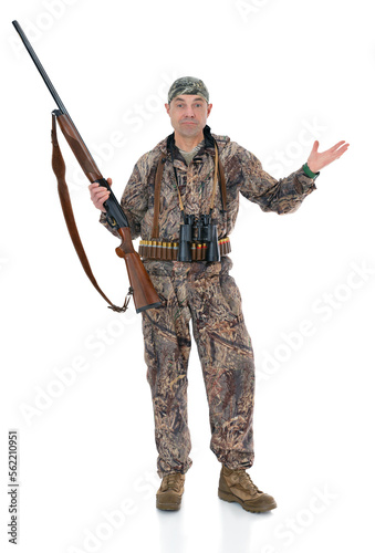 Вuck hunter with a rifle and binoculars shows that he did not hunt anything. Fifty-year-old man in hunting uniform standing in studio, isolated on white background. Full length portrait of a hunter.