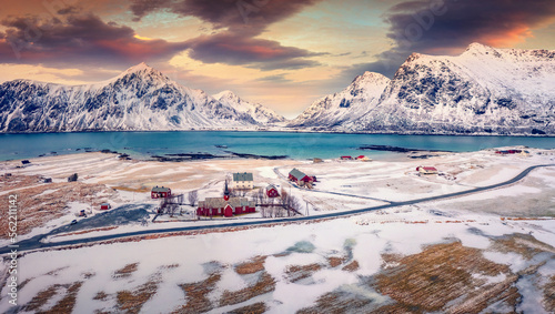 Extraordinary spring scene of Lofoten Islands. View from flying drone of Flakstad village with Hustinden mount on background, Norway, Europe. Impressive morning landscape with Flakstad church. photo