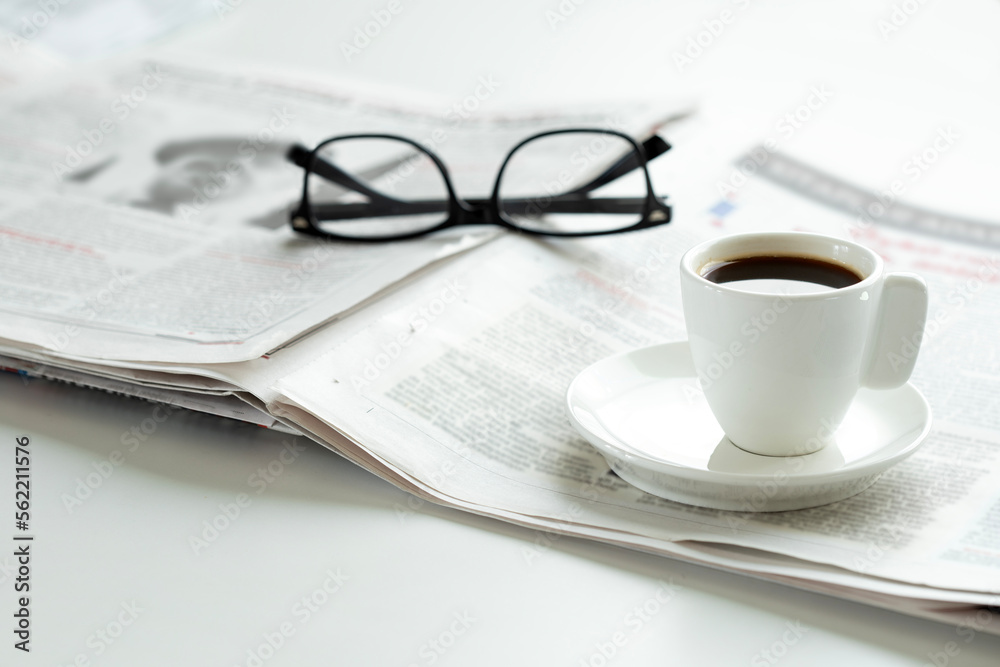 newspaper and eyeglasses on office desk newspaper and eyeglasses on office desk