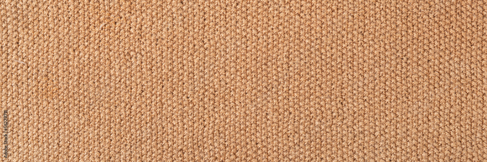 Knitted beige background. Large knitted fabric with a pattern. Close-up of a knitted blanket. Horizontal ornament. Banner Knitted beige background. Large knitted fabric with a pattern. Close-up of a knitted blanket. Horizontal ornament. Banner