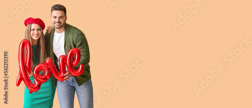 Happy young couple with bal...