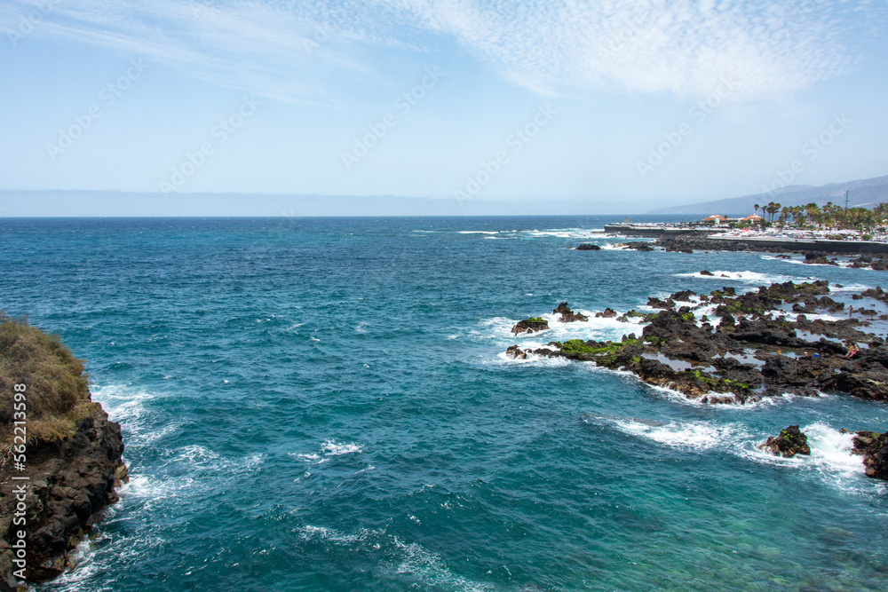 View of the coast and town of Puerto de la Cruz, Tenerife, Spain, with lava stones in the sea View of the coast and town of Puerto de la Cruz, Tenerife, Spain, with lava stones in the sea