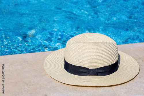 Summer hat on edge of swimming pool  closeup