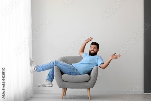 Happy young man lying in ar...