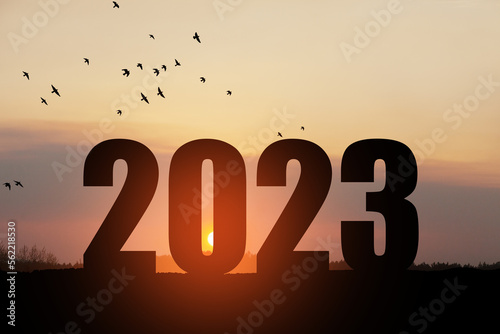 Silhouette 2023 with sunset sky at mountain and number like 2023 abstract background. Concept of start with strategy, win, plan, goal and objective target.