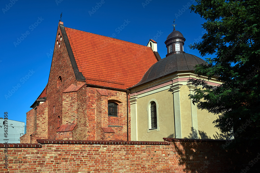 medieval, historic church behind a brick wall