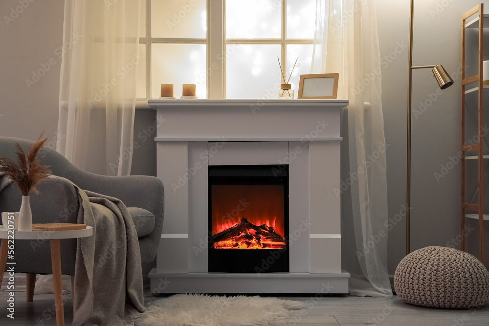 Interior of modern living room with electric fireplace and armchair Interior of modern living room with electric fireplace and armchair