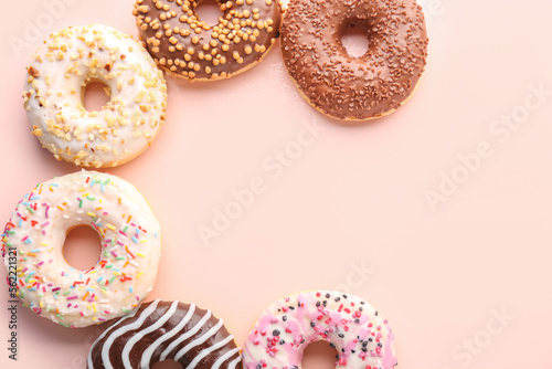 Different sweet donuts on pink background