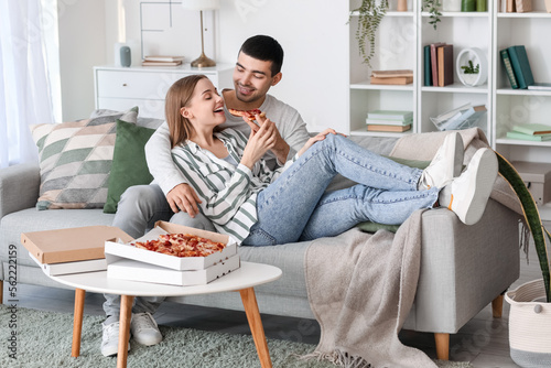 Happy young couple eating t...