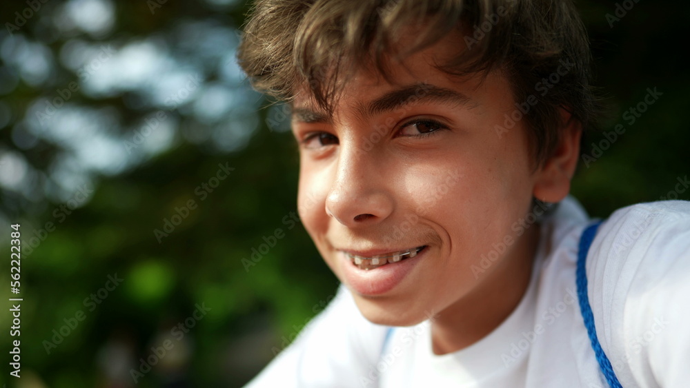 Smiling handsome young boy portrait face close-up outside in sunny day Smiling handsome young boy portrait face close-up outside in sunny day