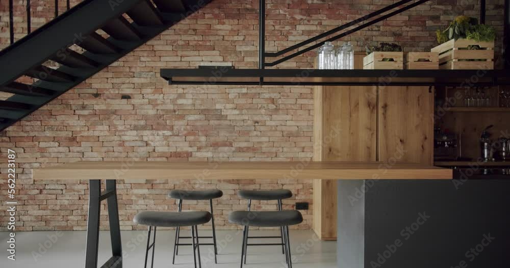 Modern and spacious wooden kitchen room with wall bricks and black