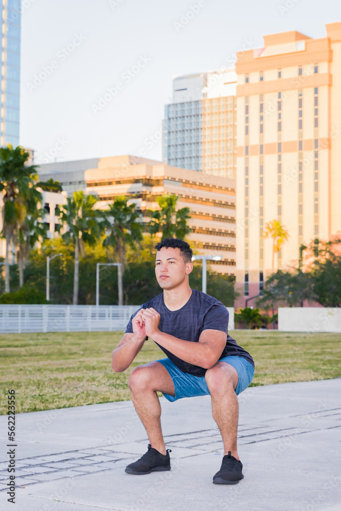Young muscular man exercising outdoor, city park, downtown, summer. healthy lifestyle concept.