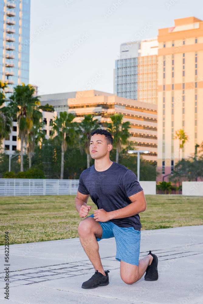 Young muscular man exercising outdoor, city park, downtown, summer. healthy lifestyle concept.