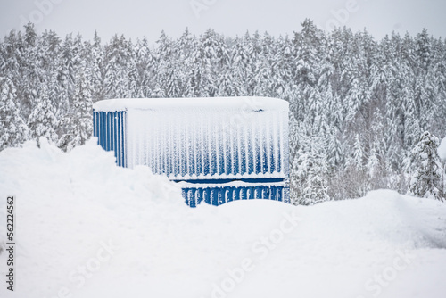 Two blue containers in deep snow.