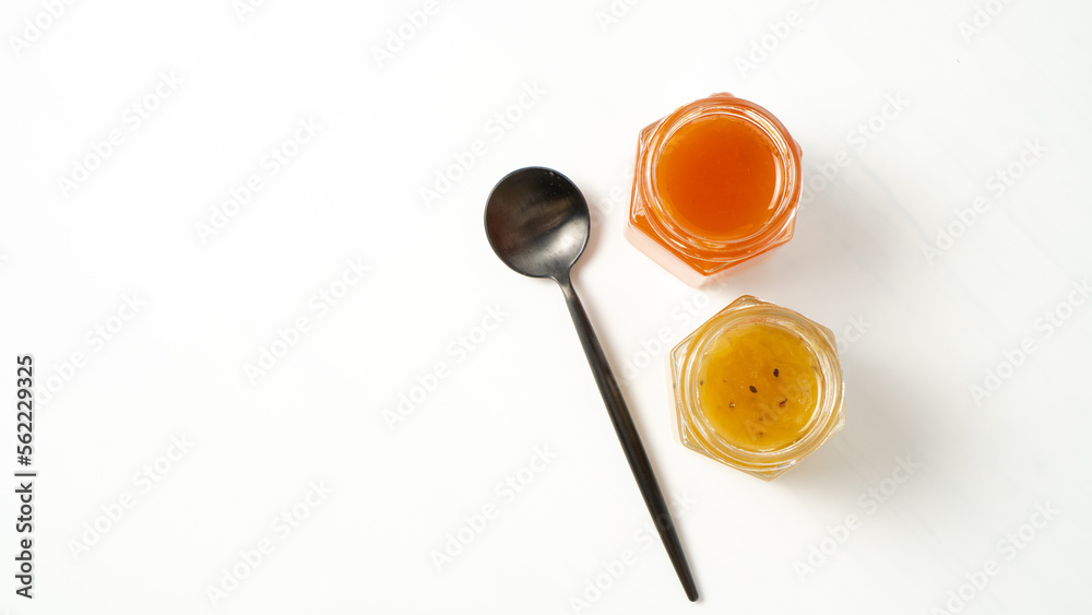 Two isolated jam jars on white background. Delisious jam. Jam containers with space for text Two isolated jam jars on white background. Delisious jam. Jam containers with space for text