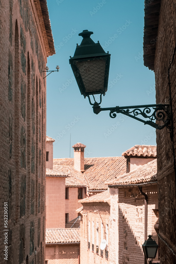 Toledo, España. April 29, 2022: Streets and facades in the city of Toledo with blue sky.