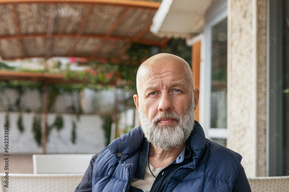 close-up portrait of a handsome adult man with gray hair in a cafe on the street. High quality photo close-up portrait of a handsome adult man with gray hair in a cafe on the street. High quality photo