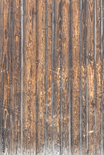 A texture of brown boards with knots and resin painted with impregnation for wood. Vertical