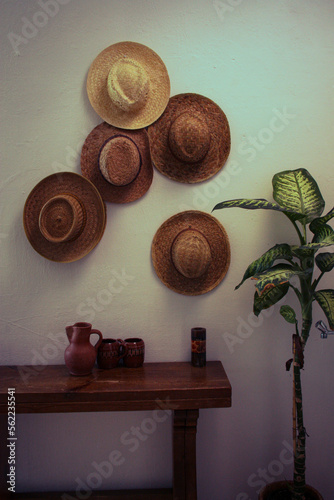 Straw hats on the wall photo