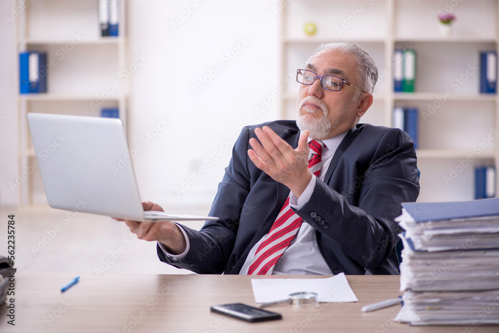 Old male employee and too much work in the office Old male employee and too much work in the office