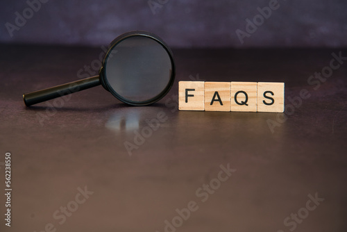 Faq, frequent questions in wooden letters