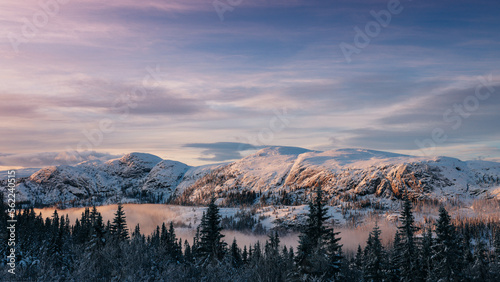 Mountain peak during sunrise . Natural landscape in the Norway at winter time. photo