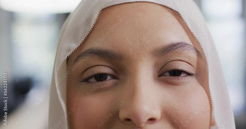 Portrait of biracial businesswoman wearing hijab in office, slow motion Portrait of biracial businesswoman wearing hijab in office, slow motion