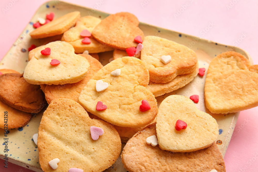 Plate with sweet heart shaped cookies and sprinkles on pink background, closeup. Valentines Day celebration Plate with sweet heart shaped cookies and sprinkles on pink background, closeup. Valentines Day celebration