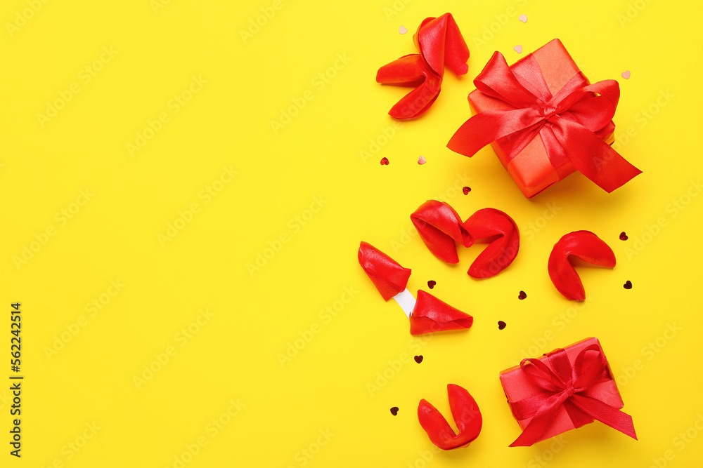 Composition with tasty fortune cookies and gift boxes on yellow background. Valentine's Day celebration Composition with tasty fortune cookies and gift boxes on yellow background. Valentine's Day celebration