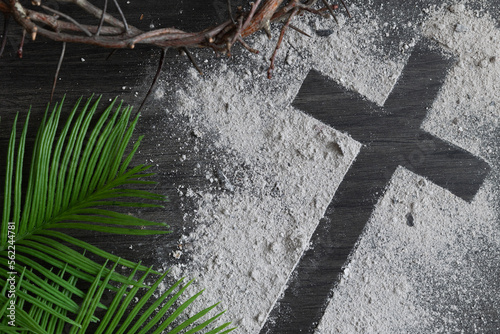 Obraz na plátně Lent background with cross of ashes, palm leaves and partial crown of thorns on
