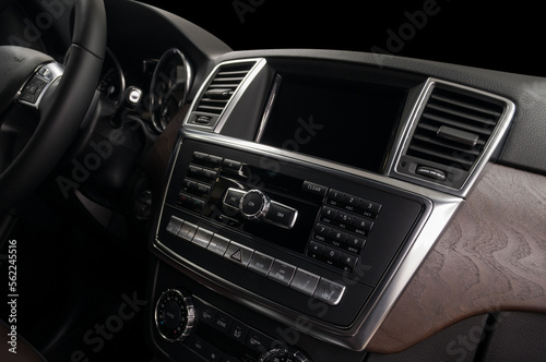 Car interior detail. Multimedia screen and dashboard with control buttons.