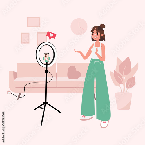 Blogger, Influencer. Flat style vector illustration. A girl recording a vlog on the front camera. Young female blogger records herself on video using a light lamp. Vlogger cartoon character.