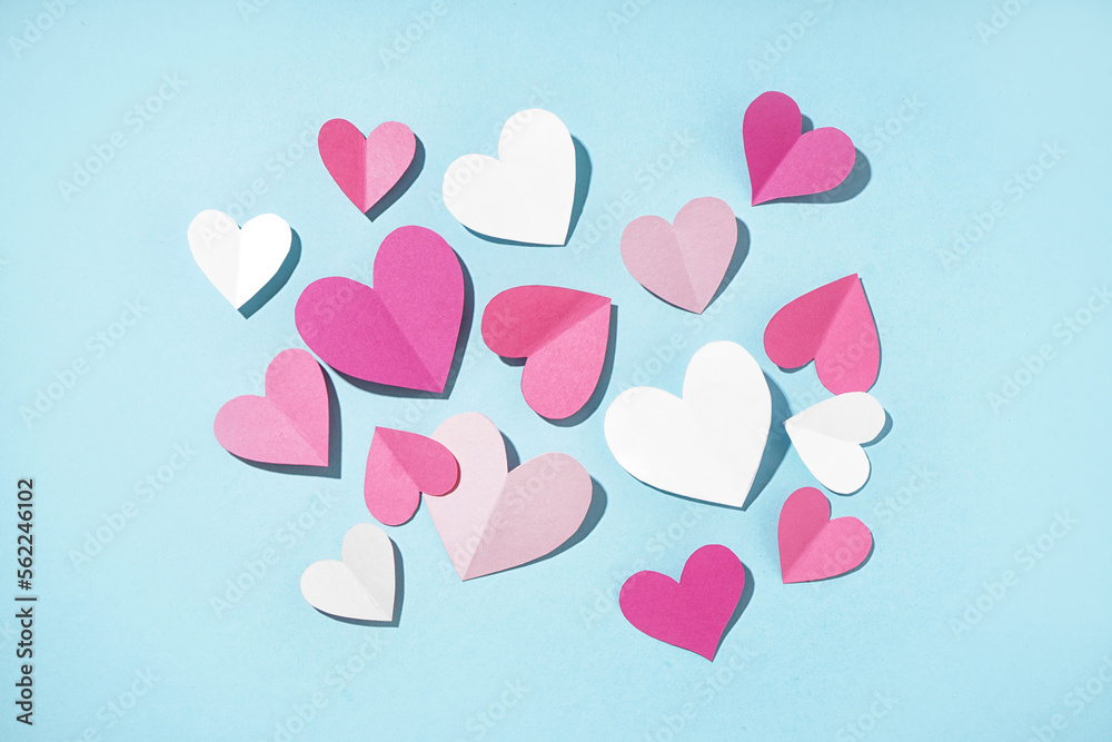 Beautiful paper hearts on blue background. Valentines Day celebration