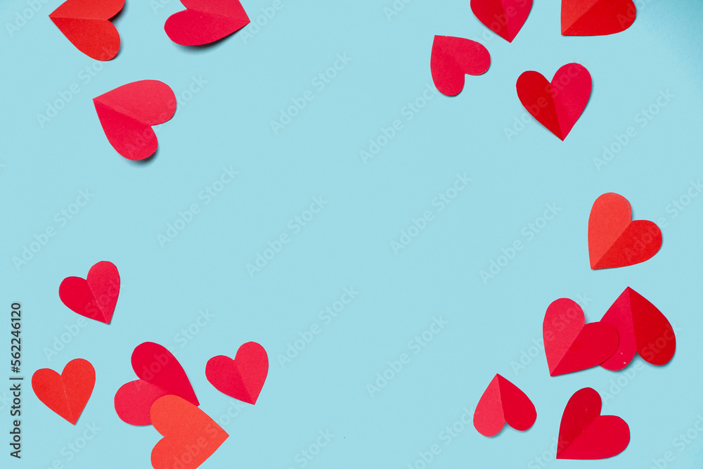 Frame made of paper hearts on blue background. Valentines Day celebration