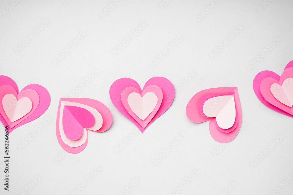Composition with paper hearts on light background. Valentines Day celebration Composition with paper hearts on light background. Valentines Day celebration