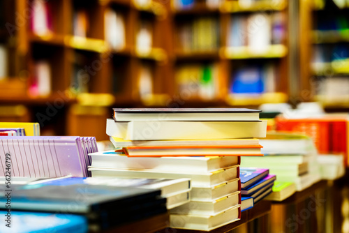 Blurred bookstore with books on tables and shelves. Education, school, study, reading fiction concept