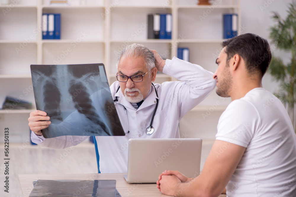 Young male patient visiting old male doctor radiologist