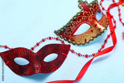 Carnival masks with beads on blue background