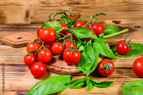 Heap of small cherry tomatoes on wooden table