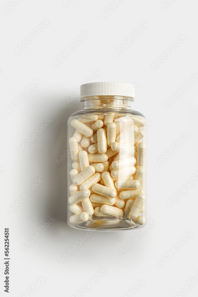 Transparent bottle with pills on white background, top view Transparent bottle with pills on white background, top view