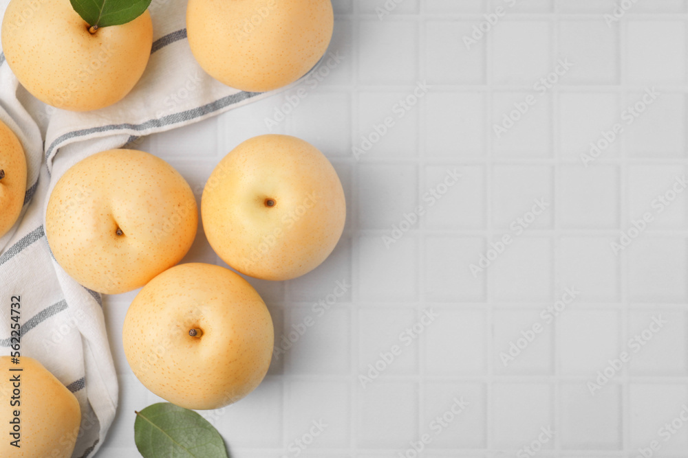 Delicious apple pears on white tiled table, flat lay. Space for text Delicious apple pears on white tiled table, flat lay. Space for text