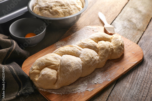 Φωτογραφία Homemade braided bread and ingredients on wooden table, above view