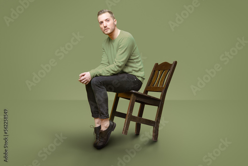 Картината върху платно handsome guy tilt with chair while look at camera and pose