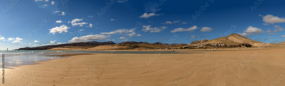 spiaggia infinita 01 - panoramica con oceano, spiaggia dorata e montagne vulcaniche nere