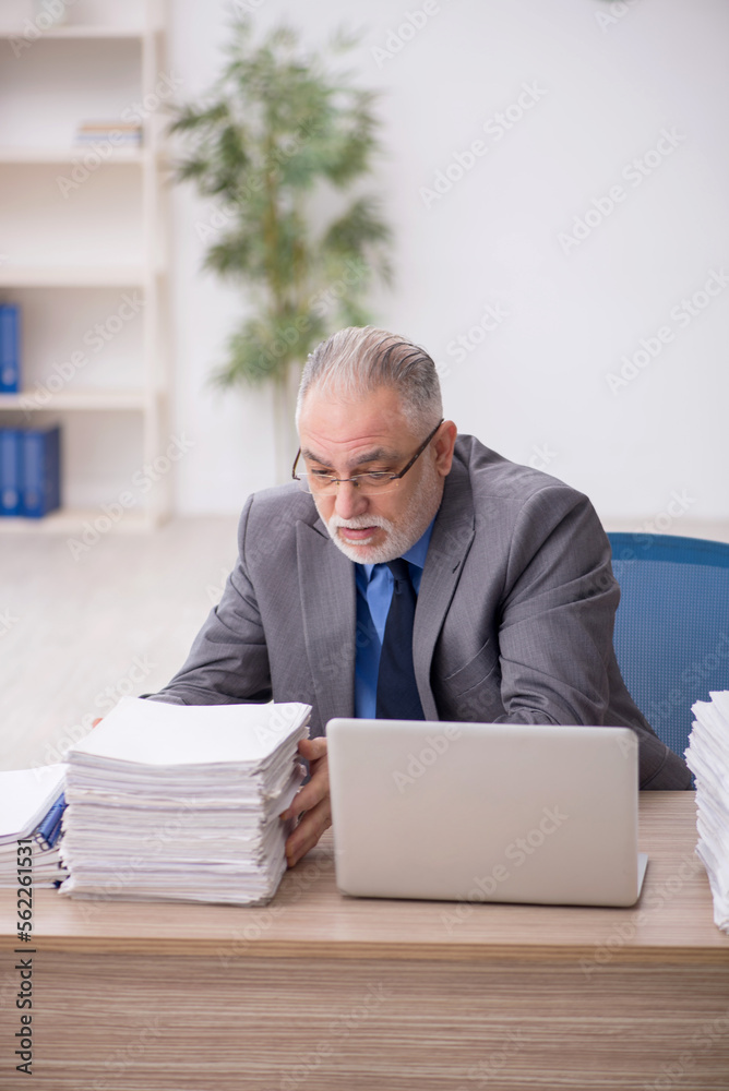 Old male employee and too much work in the office Old male employee and too much work in the office