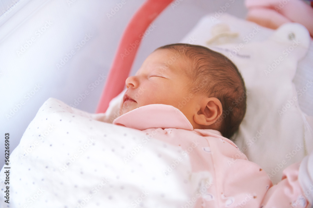 Portrait of adorable newborn baby lying in hospital crib Portrait of adorable newborn baby lying in hospital crib