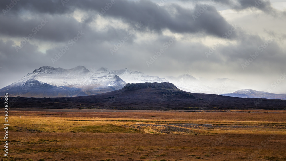 Elborg crater in Snaefellsnes Peninsula Iceland with snowy mountains in background